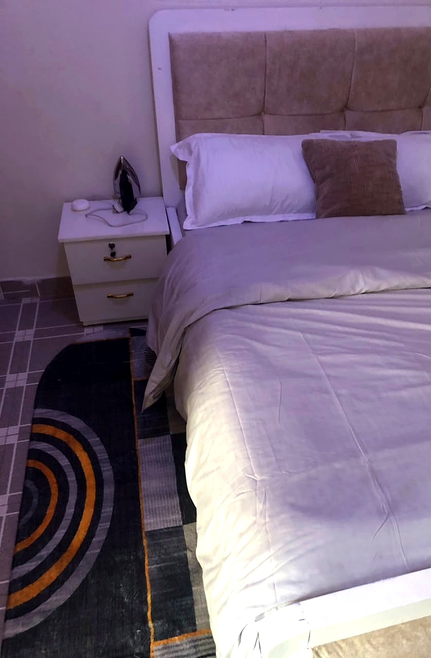 PJ's Cozzy Homes bedroom with bedside table
