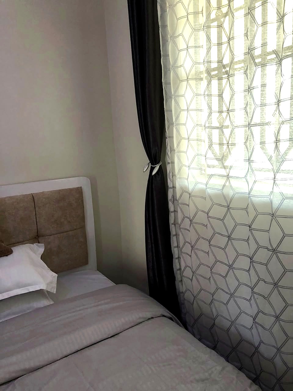 Bedroom with natural light and curtains